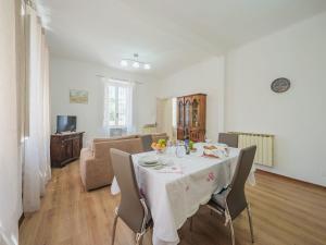 a dining room with a table and chairs and a living room at Holiday Home Casa di Giò by Interhome in Marina di Massa +20 photos