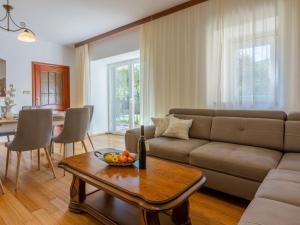 a living room with a couch and a table at Holiday Home Lukata by Interhome in Drivenik