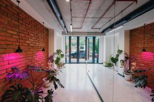 a room with plants and a brick wall at About Sololaki in Tbilisi City