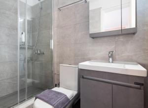 a bathroom with a toilet and a sink and a shower at Filippa City Apartments - Lefkada Town Center in Lefkada +6 photos