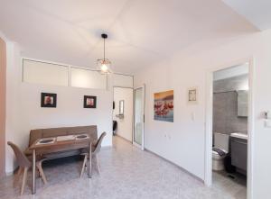 a dining room with a table and a toilet at Filippa City Apartments - Lefkada Town Center in Lefkada