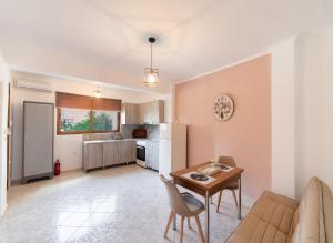 a living room with a table and a kitchen at Filippa City Apartments - Lefkada Town Center in Lefkada