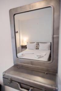 a mirror reflection of a bed in a room at Filippa City Apartments - Lefkada Town Center in Lefkada