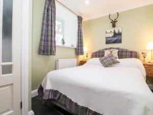 a bedroom with a bed and a window at The Lantern in Kendal