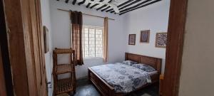 a bedroom with a bed and a window at Karikila in Paje