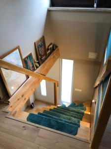 una scala in una piccola casa con tappeto verde di Ferienhaus "Buddelschiff" a Ueckermünde