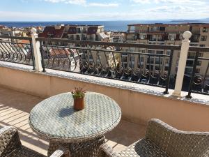 a table and chairs on a balcony with a view at Grand Sea View Penthouse in Sveti Vlas