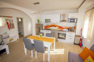 a kitchen and dining room with a table and chairs at HOLIDAY HOME KATE in Vis