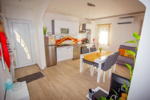 a kitchen and living room with a table and a dining room at HOLIDAY HOME KATE in Vis