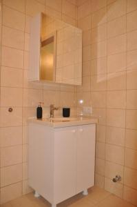 a bathroom with a sink and a mirror at Apartmany Paradiso Shekvetili in Shekvetili