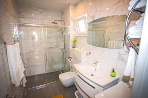 a bathroom with a shower and a sink and a toilet at HOLIDAY HOME KATE in Vis