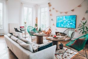 a living room with a couch and chairs at Le Petit Château de Conteville in Paluel