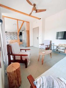 a living room with two beds and a ceiling fan at ZeusPlace Anastasia's Apartment 1 in Litochoro