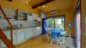 a kitchen with a blue table and chairs in it at Panoramer in Théoule-sur-Mer