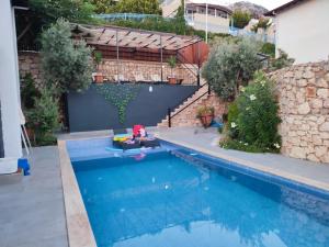 a swimming pool in the backyard of a house at Villa MK in Kalkan