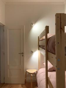 a bedroom with two bunk beds and a door at Nº7 Sacadura Cabral in Guarda