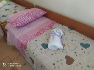 a stuffed animal is sitting on a bed at b&b chalet la vigna intera struttura in Scurcola Marsicana