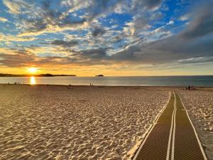 una vista de la playa al atardecer con una pista en la arena en Sole, en Ajo