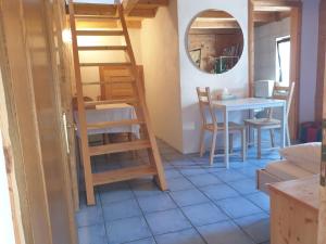 a room with a table and chairs and a ladder at Homestay Sleepy Traveler in Sankt Georgen im Attergau