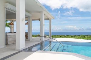 una vista exterior de una casa con piscina en Incredible views of sea from the pool - Cool Breeze villa, en Saint James