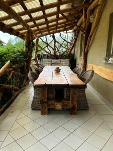 a wooden table and chairs on an outdoor patio at CHILL Village in Nowinka