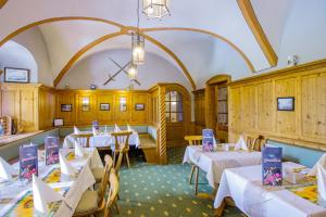 a dining room with white tables and chairs at Hotel Schloss Nebra in Nebra