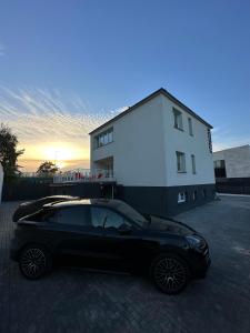 um carro preto estacionado em frente a um edifício em Elbląska Noclegi em Lódź