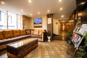 a living room with a couch and a table at Hotel Himalayan Retreat in Darjeeling