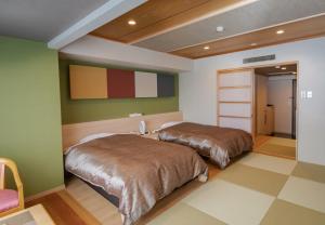 Postel nebo postele na pokoji v ubytování Kirishima Hotel + 18 fotografií