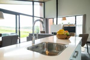a kitchen sink with a bowl of fruit on it at Villas Winterberg in Winterberg +50 photos