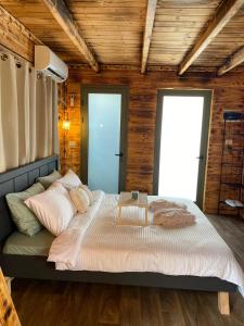 ein Schlafzimmer mit einem großen Bett in einem Zimmer mit Holzwänden in der Unterkunft T&S suite in Dāliyat el Karmil