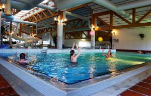 three women playing in a swimming pool at Nice apartment close to Bardufoss Hotel - minimum 3 nights in Bardufoss