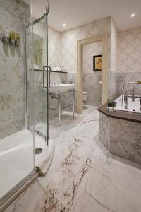 a bathroom with a shower and a tub and a sink at Perryville House in Kinsale