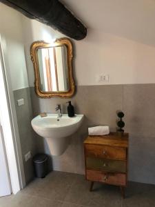 a bathroom with a sink and a mirror on the wall at Prestige Sirmione Via Antiche Mura in Sirmione