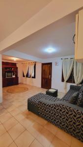a large room with two beds and a tiled floor at Oasis Appartement in Blue Bay
