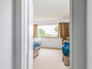 a bedroom with a bed and a large window at Pass the Keys Charming Harbourside Cottage in Emsworth