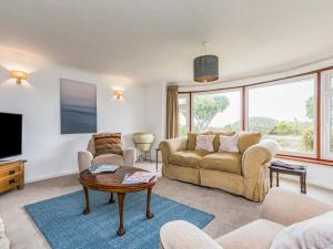a living room with a couch and a tv at Pass the Keys Charming Harbourside Cottage in Emsworth