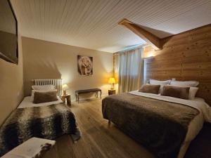 Voodi või voodid majutusasutuse Hotel Les Flocons toas