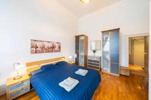 a bedroom with a blue bed in a room at Shining bright two bedroom apt next to Andrassy ave in Budapest