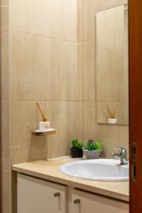 a bathroom with a sink and a mirror at Litoral beach Apartment -- Esposende in Esposende