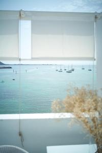 a window with a view of the water with boats at AVANTI Lifestyle Hotel - Only Adults in Corralejo