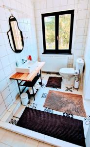 a bathroom with a sink and a toilet at Innerpeace Vendégház in Galyatető