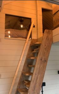 a staircase in a tiny house with a bed at Luxury Garden Lodge With Free Parking in Chestfield