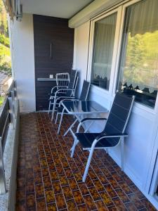 a row of chairs sitting on a porch at Haus enere Au in Todtmoos