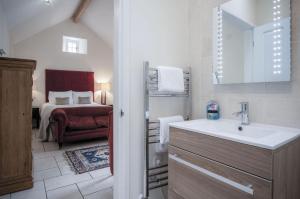 a bathroom with a sink and a bedroom with a bed at Brynach - 1 Bedroom - St Ishmaels in Saint Ishmaels