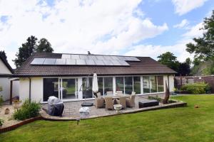 a house with solar panels on the roof at Luxury property - Swimming Pool, Games Room & Hot Tub in Usk