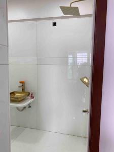 a glass shower door in a bathroom with a shelf at Luxury 3BHK Aprtmnt City View Balcony HSpeed Wifi Free Parking in Kolkata