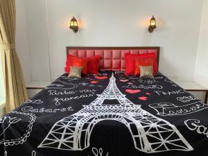 a bedroom with a bed with a black and white comforter at Luxury 3BHK Aprtmnt City View Balcony HSpeed Wifi Free Parking in Kolkata