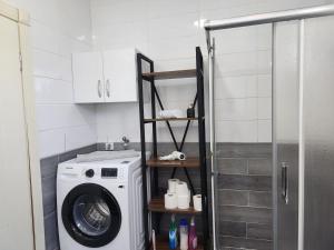 a washing machine in a bathroom with a shower at ADRASAN TATİL EVLERİ 1 in Adrasan