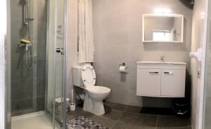 a bathroom with a toilet and a sink and a shower at Cerviola Etrin Court in Marsaskala